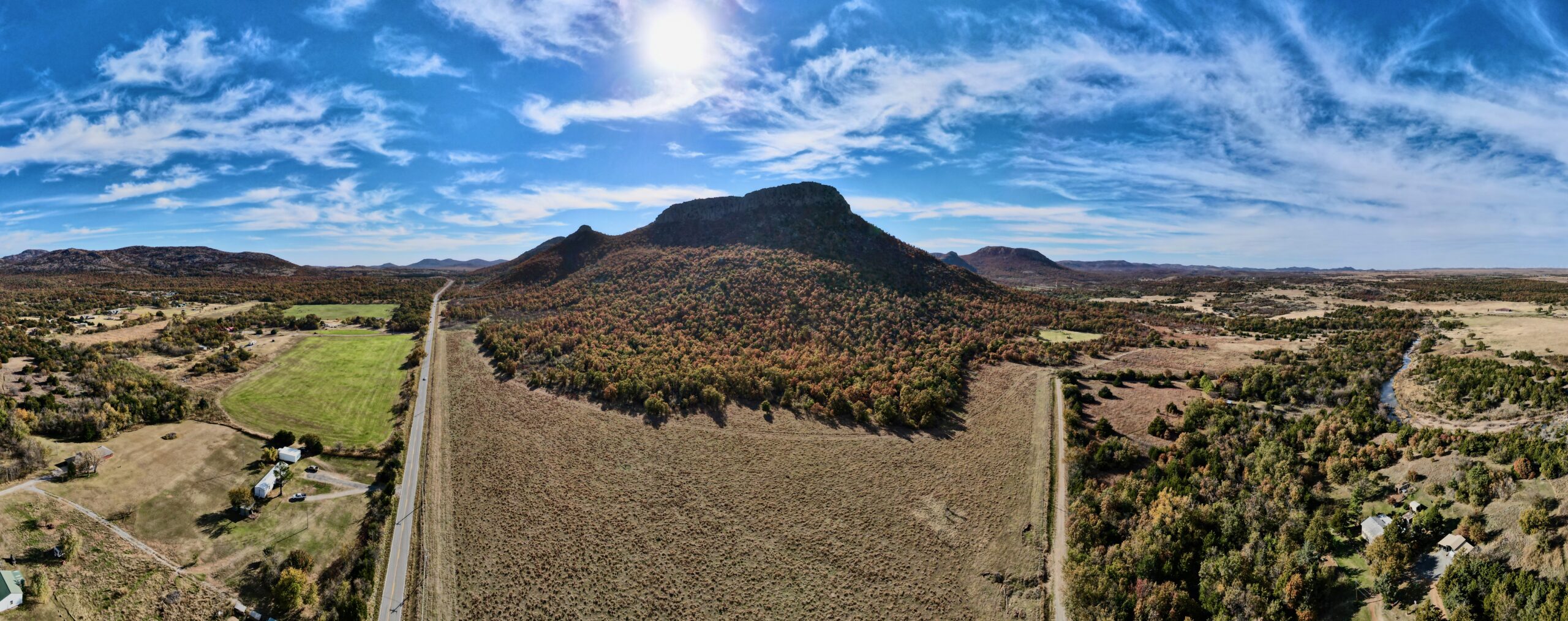 a drone pano of fall trees and the wichita mountains from meers oklahoma looking south