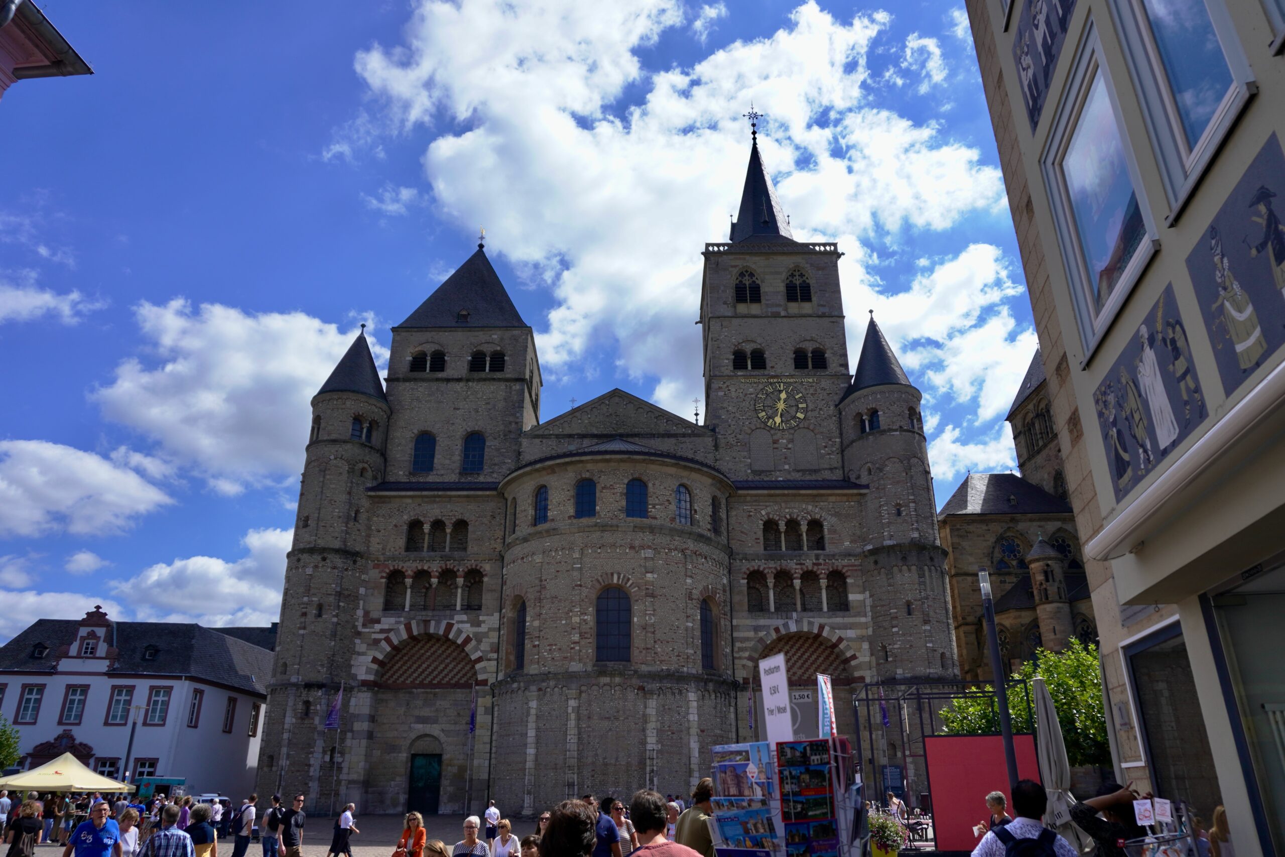 a stone church with two towers with a rounded center