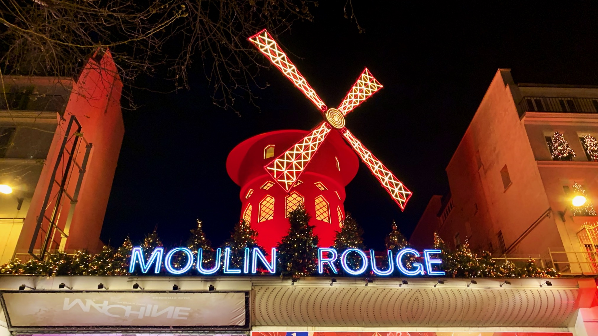 the red windmill and moulin rouge sign in paris