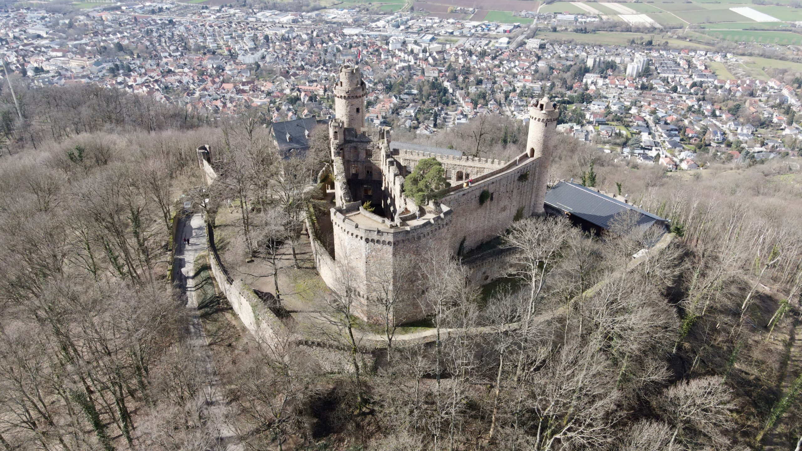 a drone picture from above with the down behind the castle and the castle in the center
