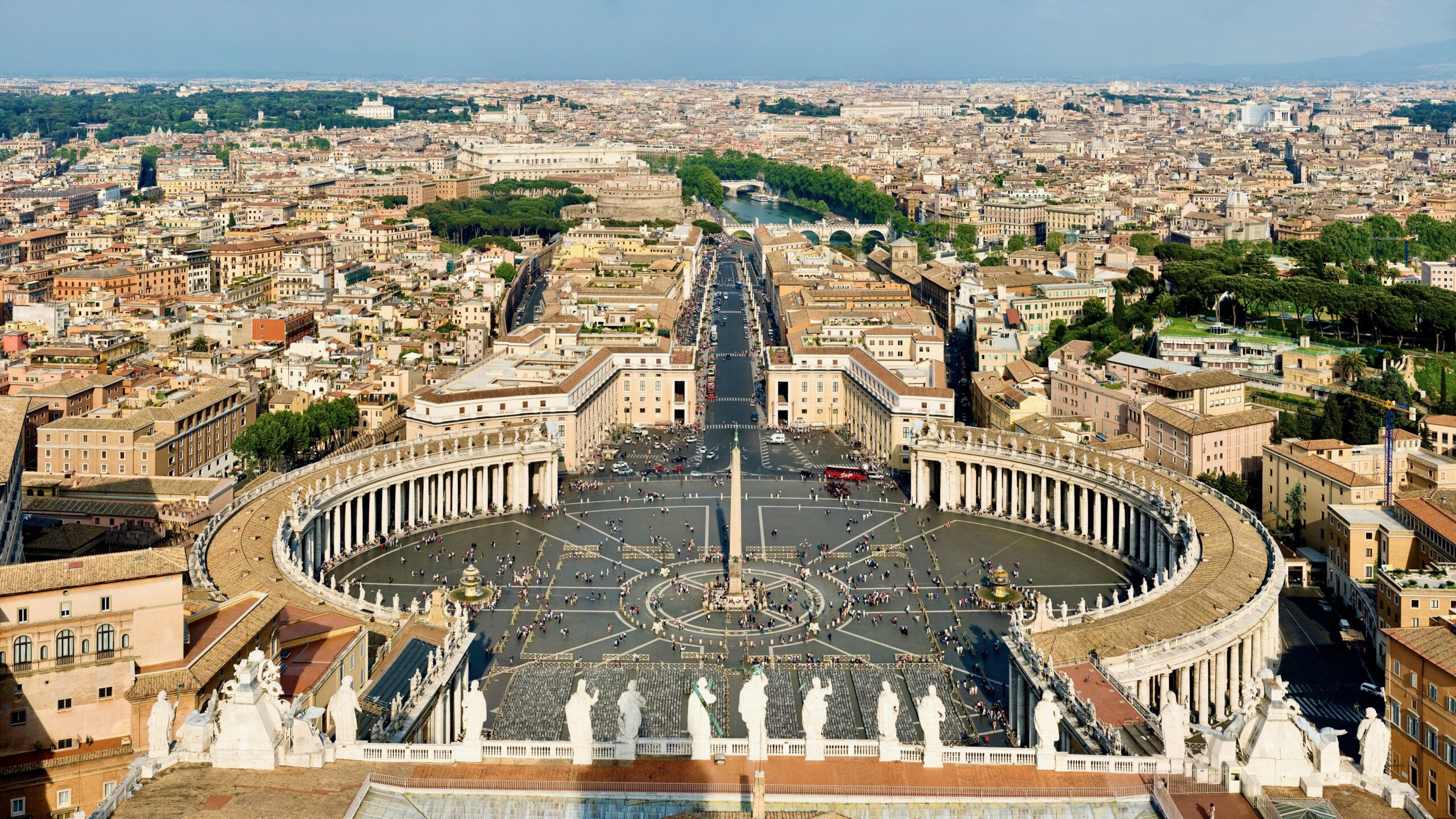 a photo from the top of the dome of st peter looking into the square with rome expanding into the distance Photo by DAVID ILIFF. License: CC BY-SA 3.0