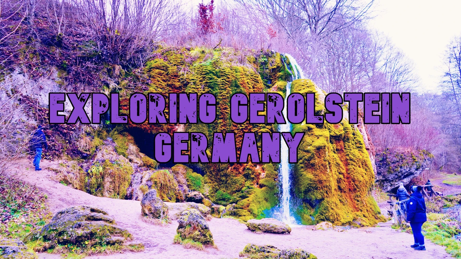 title exploring gerolsteimn Germany with a green mossy waterfall behind the title and people exploring the area