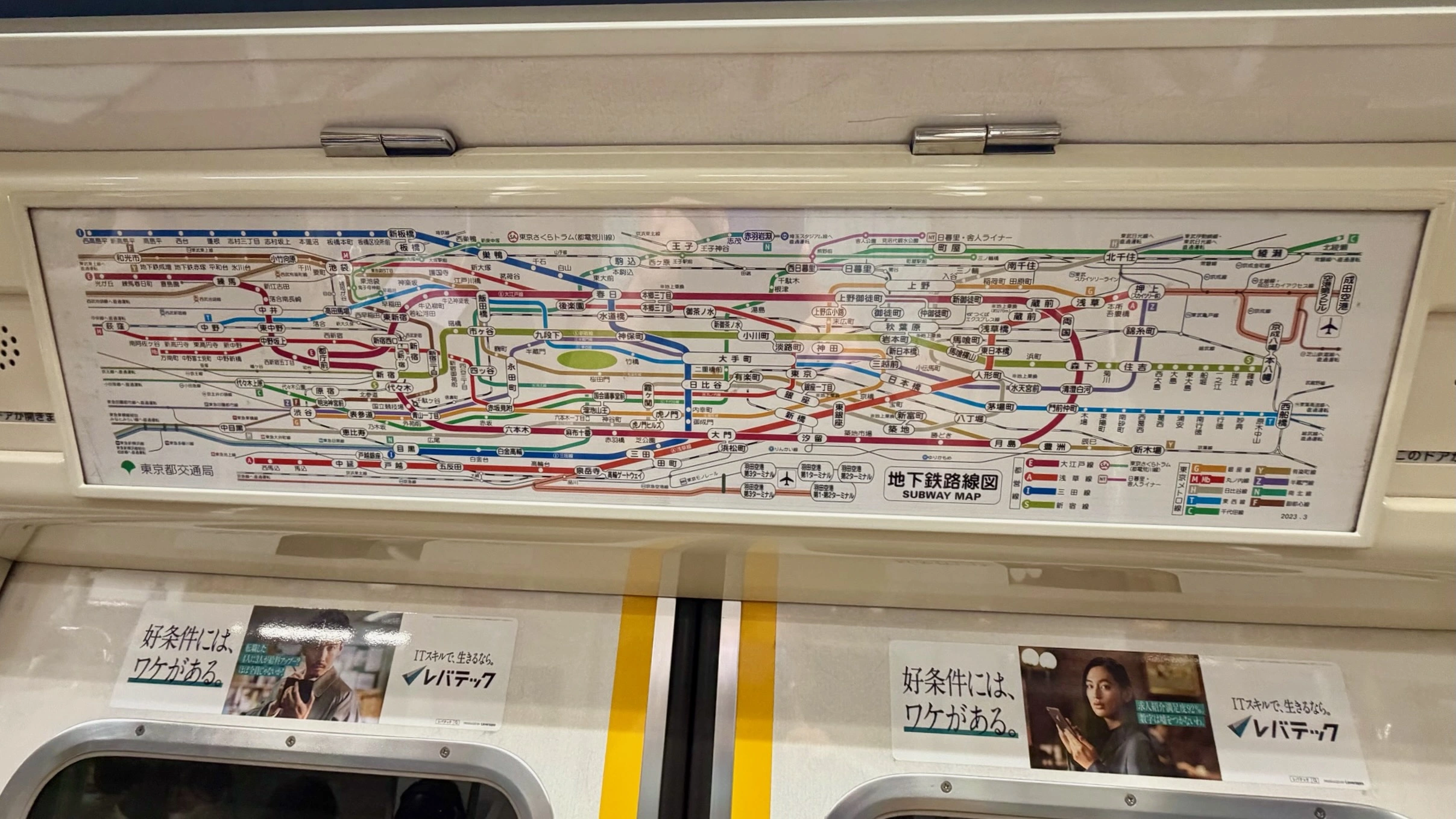 a complicated set of lines on the Tokyo subway map inside the train